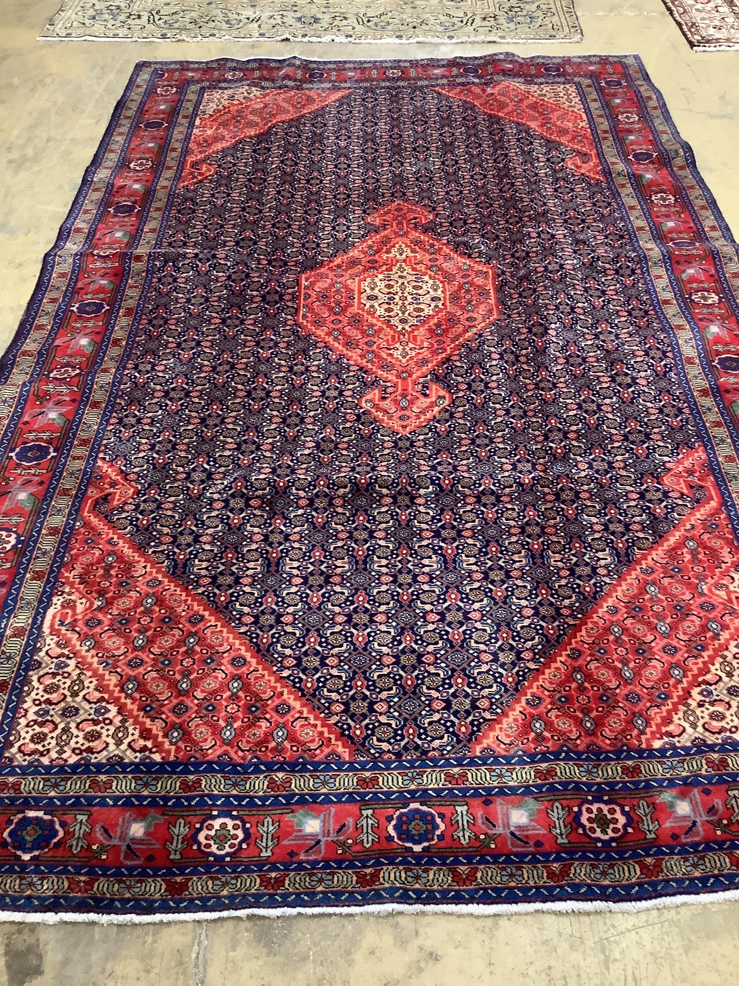 A Tabriz red ground carpet, 296 x 189cm